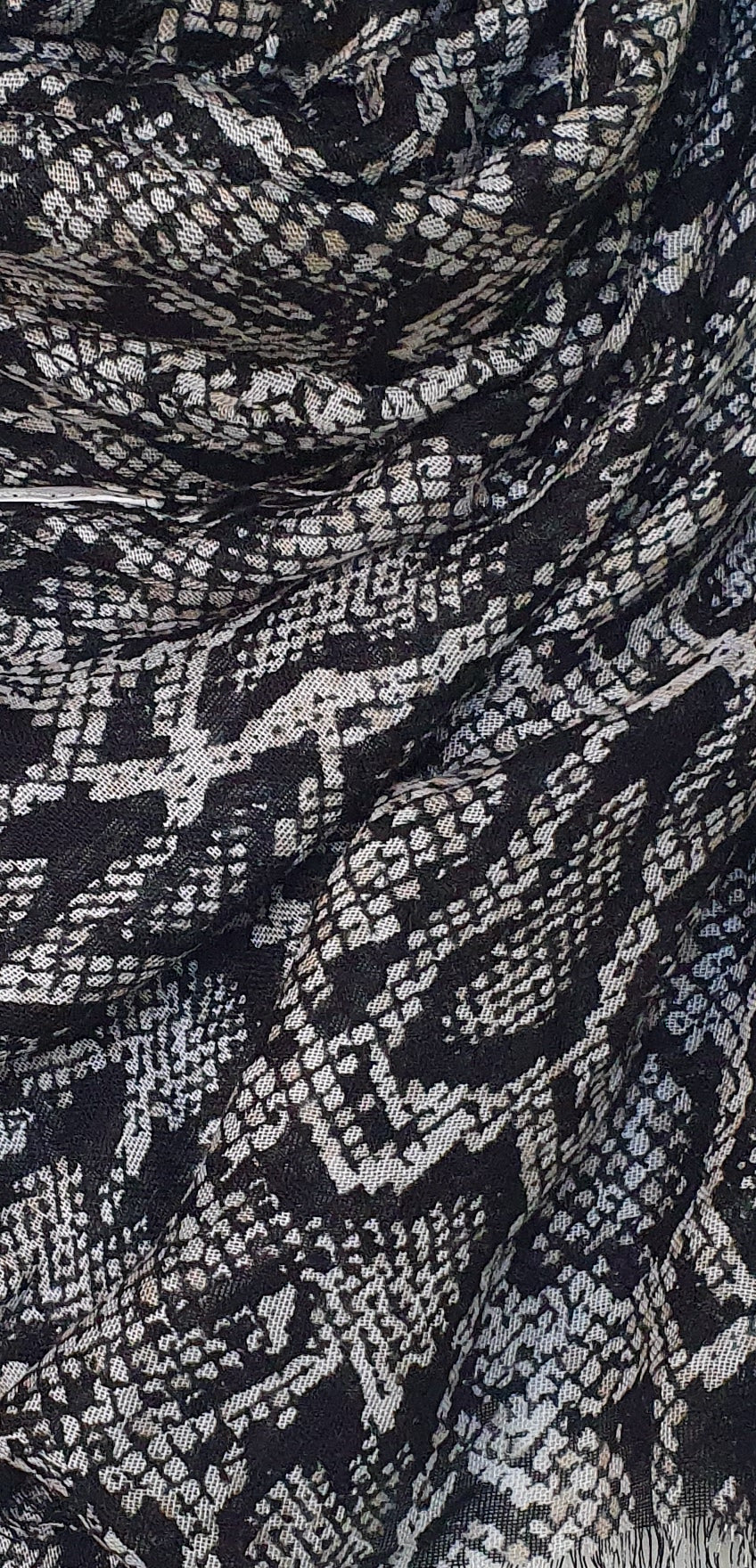 Close-up of black and white patterned J. scarf