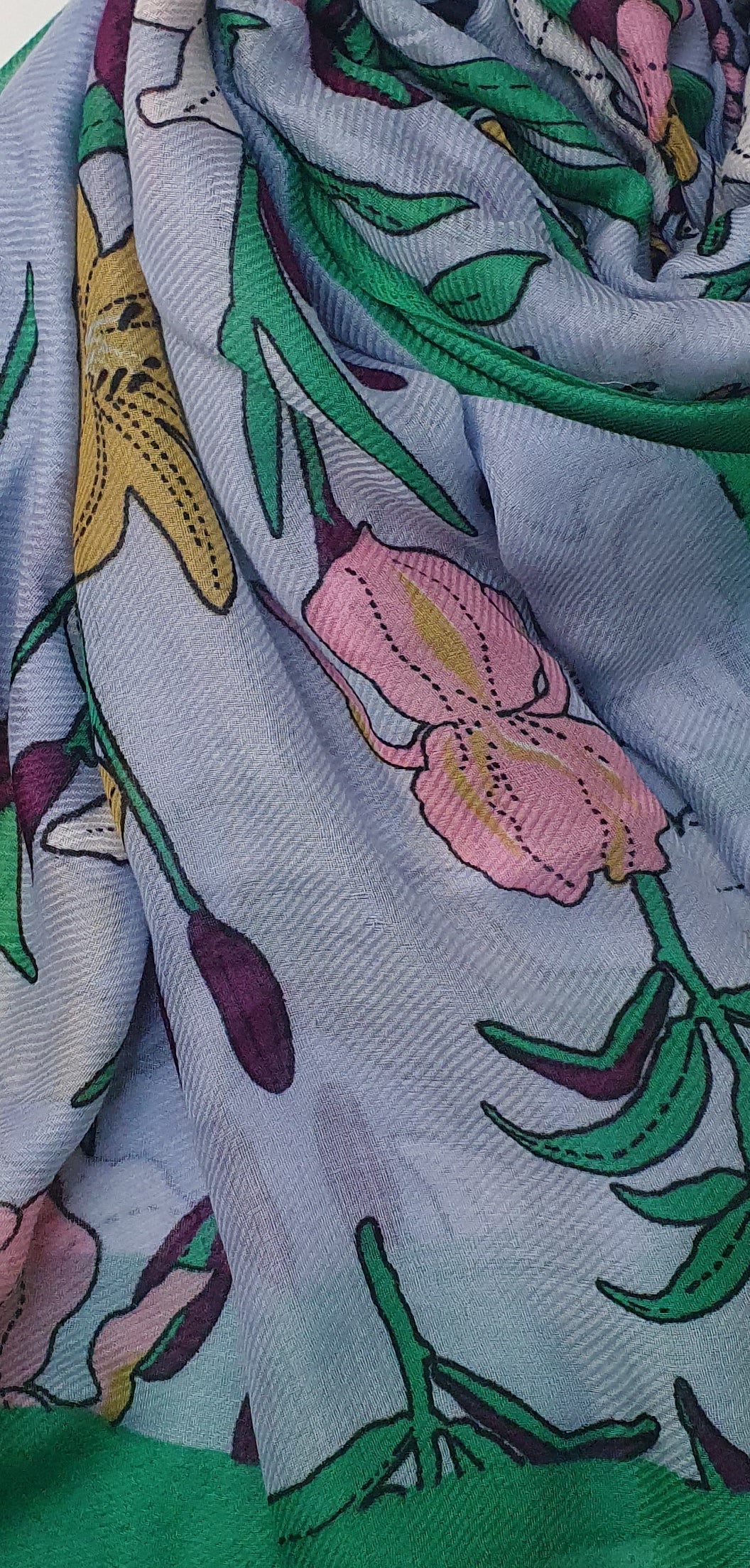 Close-up of J. stole with floral pattern featuring pink flowers and green leaves.