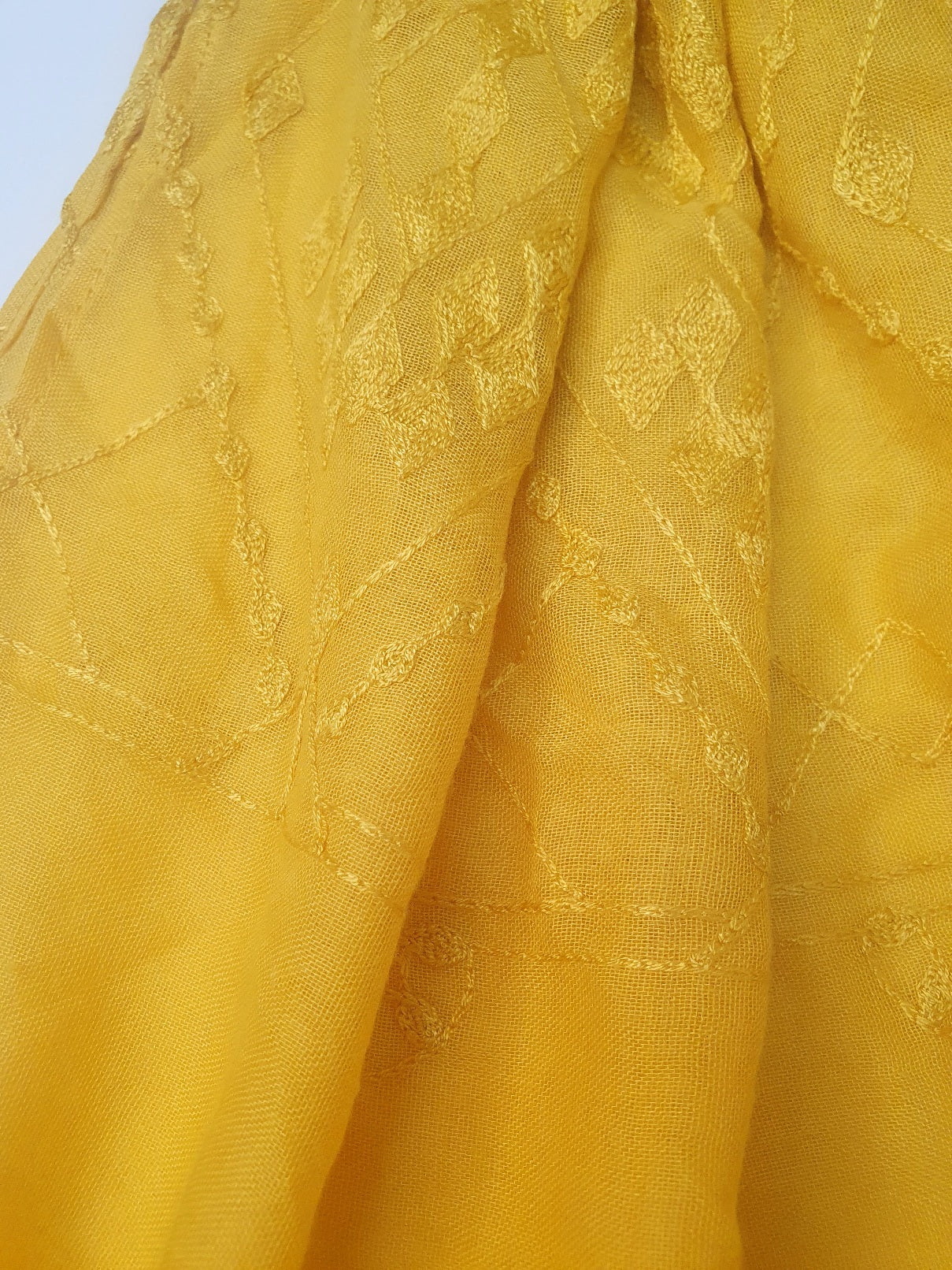 Close-up of yellow J. scarf