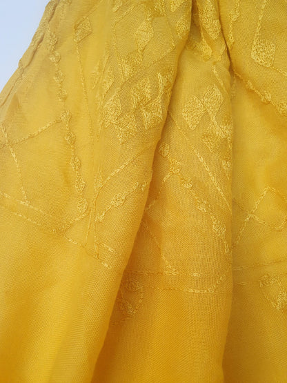 Close-up of yellow J. scarf