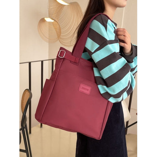 maroon shoulder bag with multiple pockets