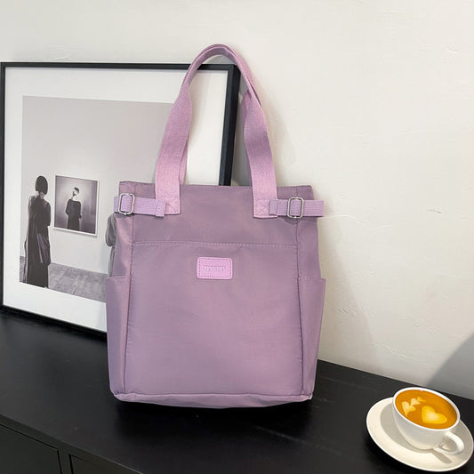purple shoulder bag with multiple pockets