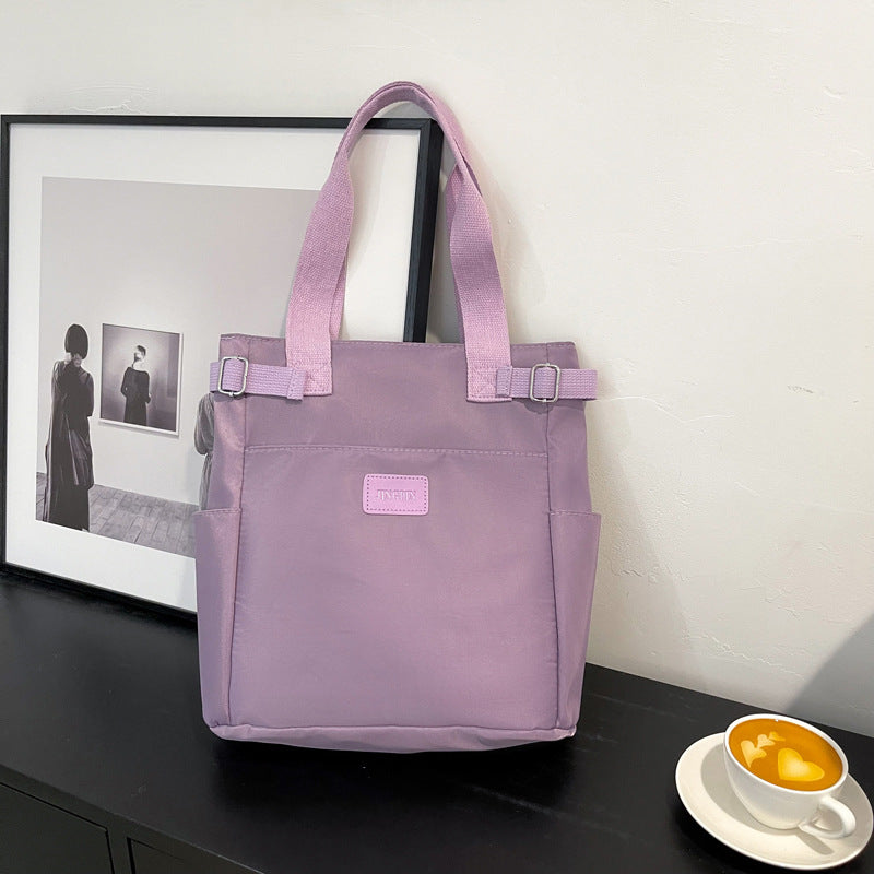 purple shoulder bag with multiple pockets